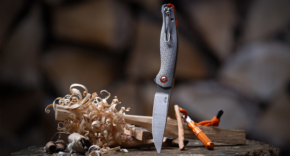 titanium knife sticking out of log in forrest